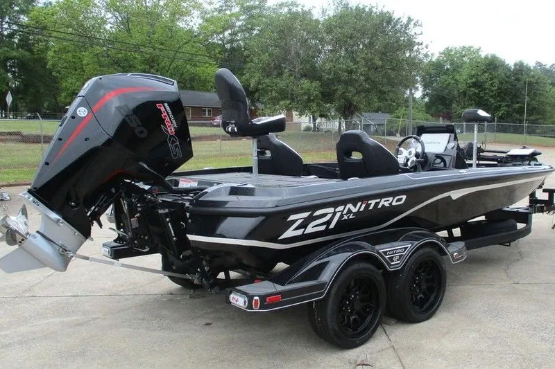 Slide: The Image of 2026 Tracker Pro Guide V-16 WT boat on trailer, featuring powerful outboard motor. - 3