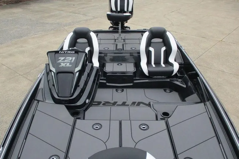 Slide: The Image of 2026 Tracker Pro Guide V-16 WT boat interior with sleek black and white seating. - 4