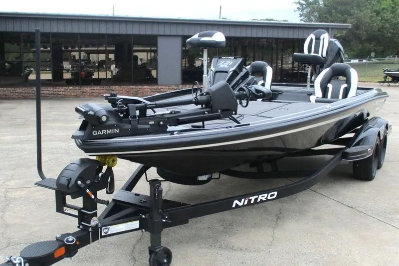 Slide: The Image of 2026 Tracker Pro Guide V-16 WT boat on trailer, featuring Garmin equipment. - 5