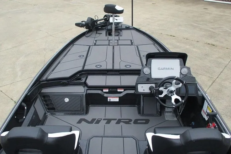 Slide: The Image of 2026 Tracker Pro Guide V-16 WT boat interior with Garmin navigation system and steering wheel. - 8