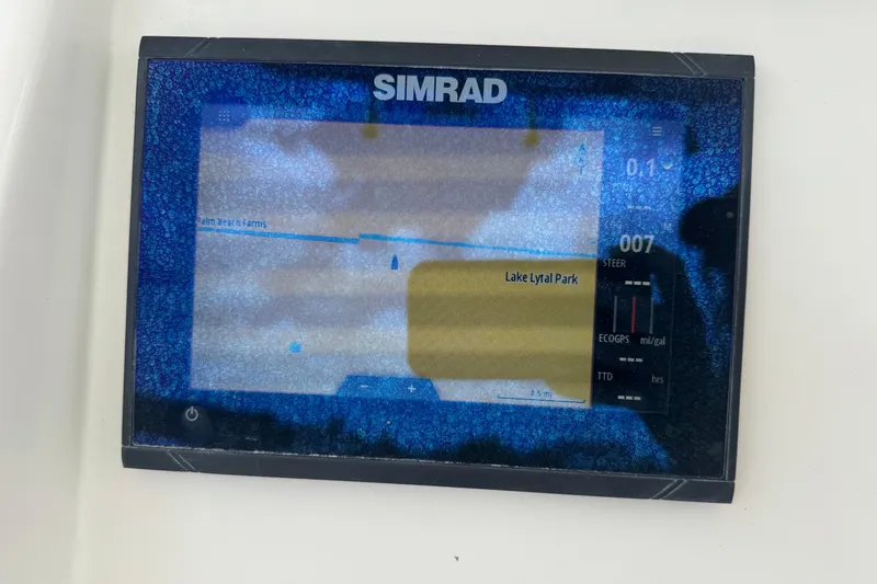 Slide: The Image of Simrad navigation display on 2023 Sailfish 242 CC boat, showing map and data. - 11