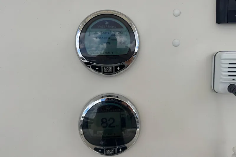 Slide: The Image of Close-up of 2023 Sailfish 242 CC boat gauges displaying volts and fuel information. - 14
