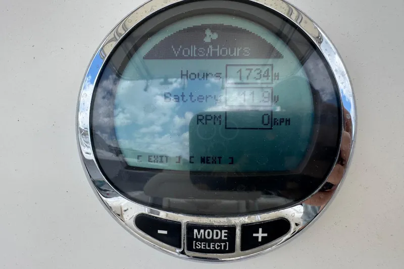 Slide: The Image of Close-up of a Sailfish 242 CC 2023 boat display showing hours and battery voltage. - 15