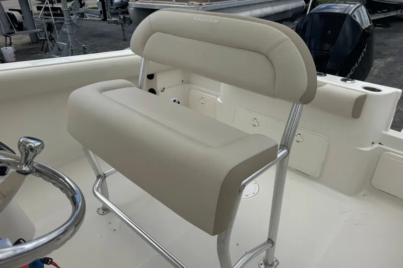 Slide: The Image of 2023 Sailfish 242 CC boat seat with beige upholstery and stainless steel frame. - 19