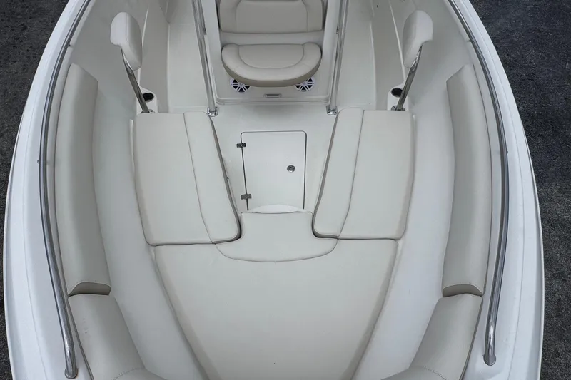 Slide: The Image of 2023 Sailfish 242 CC boat interior with cushioned seating and stainless steel railings. - 21