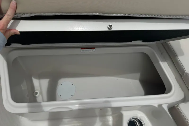 Slide: The Image of Storage compartment on a 2023 Sailfish 242 CC boat, open and empty. - 24
