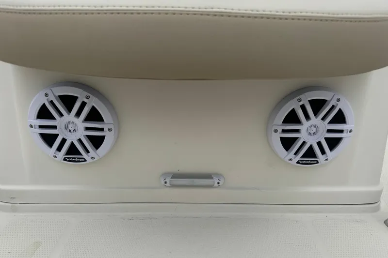 Slide: The Image of 2023 Sailfish 242 CC boat speakers, Rockford Fosgate, mounted on beige interior panel. - 25