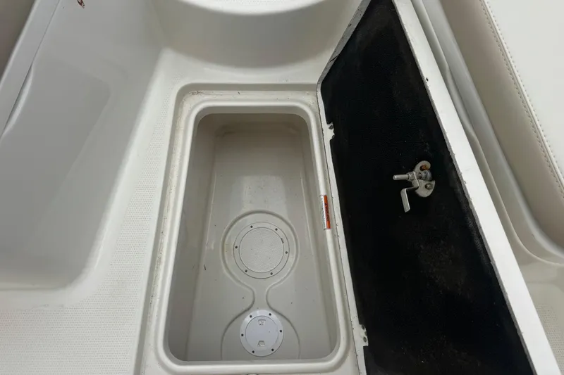 Slide: The Image of Storage compartment on 2023 Sailfish 242 CC boat, featuring a secure latch mechanism. - 26
