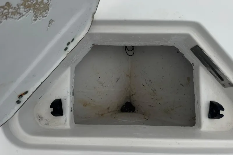 Slide: The Image of Open storage compartment on a 2023 Sailfish 242 CC boat, showing interior details. - 27