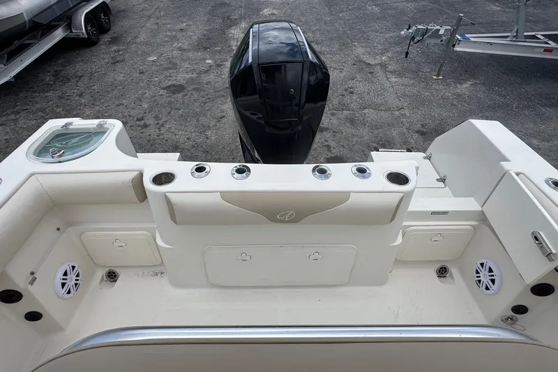 Slide: The Image of 2023 Sailfish 242 CC boat deck with motor and storage compartments. - 28