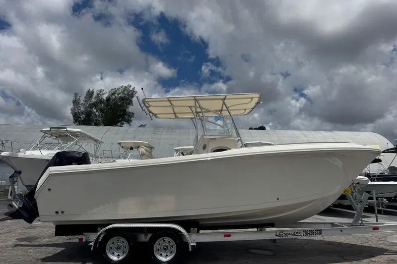 Slide: The Image of 2023 Sailfish 242 CC boat on trailer under cloudy sky. - 3
