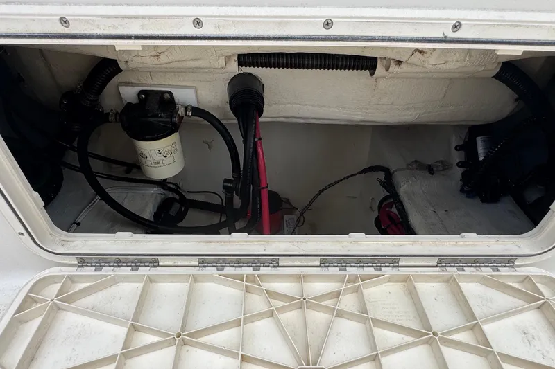 Slide: The Image of 2023 Sailfish 242 CC boat compartment with wiring and filter system. - 30