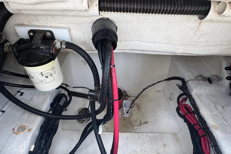 Slide: The Image of 2023 Sailfish 242 CC boat wiring and filter system in the engine compartment. - 31