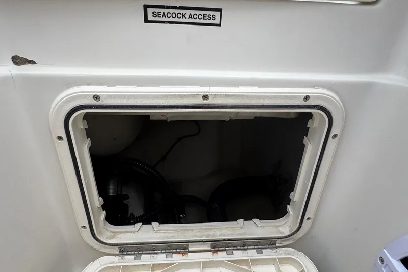 Slide: The Image of Seacock access panel on 2023 Sailfish 242 CC boat, open for maintenance. - 32