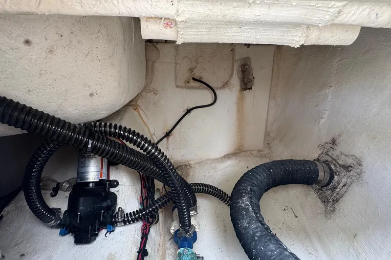 Slide: The Image of Interior view of 2023 Sailfish 242 CC boat showing wiring and hoses. - 33