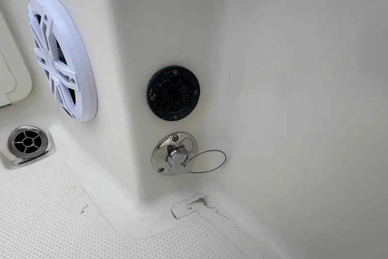 Slide: The Image of 2023 Sailfish 242 CC boat interior showing speaker and drainage system. - 34