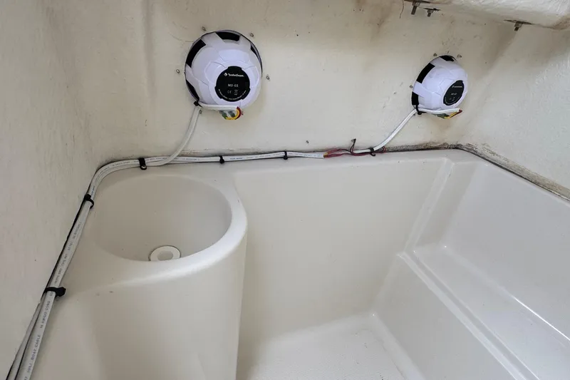 Slide: The Image of Interior of 2023 Sailfish 242 CC boat featuring speakers and wiring setup. - 37