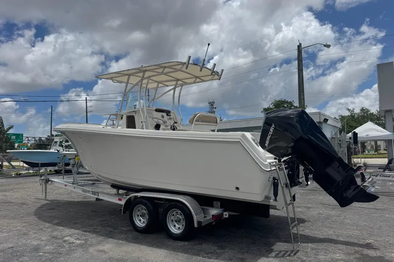 Slide: The Image of 2023 Sailfish 242 CC boat on trailer under cloudy sky. - 4