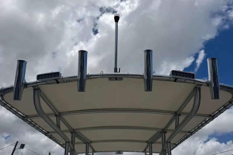 Slide: The Image of T-top of 2023 Sailfish 242 CC boat with rod holders against cloudy sky. - 40
