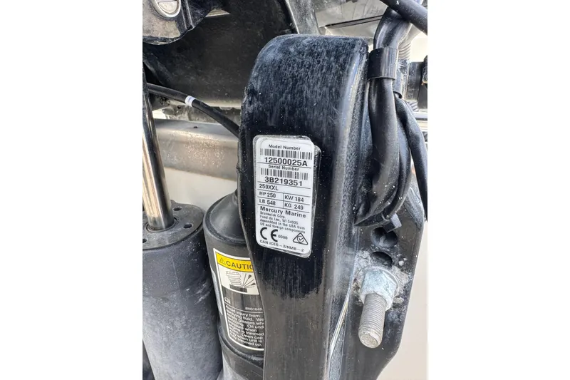 Slide: The Image of Close-up of a 2023 Sailfish 242 CC boat engine label and components. - 45