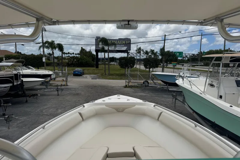 Slide: The Image of 2023 Sailfish 242 CC boat displayed at a marina with other boats. - 7