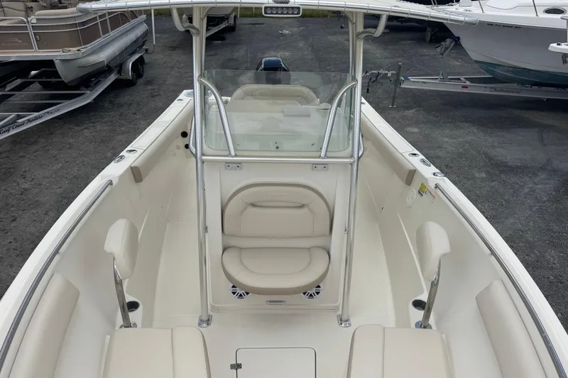 Slide: The Image of 2023 Sailfish 242 CC boat interior with seating and console, showcasing modern design. - 8
