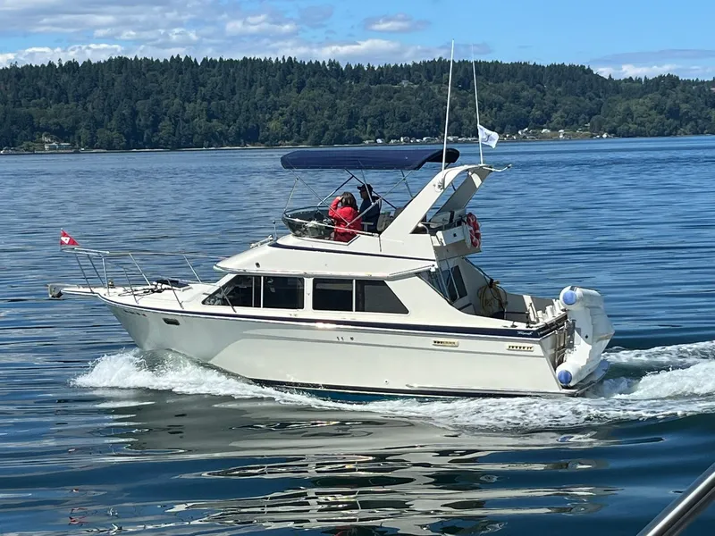 The Image of 1988 Tollycraft Sport Sedan cruising on calm waters. - 0