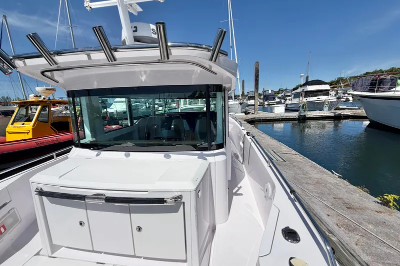 Slide: The Image of 2020 Axopar 37 XC Cross Cabin docked at a marina under clear blue skies. - 13