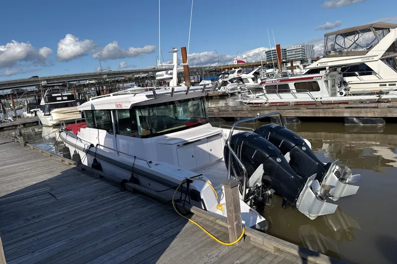 Slide: The Image of 2020 Axopar 37 XC Cross Cabin docked at a marina with twin outboard engines. - 3