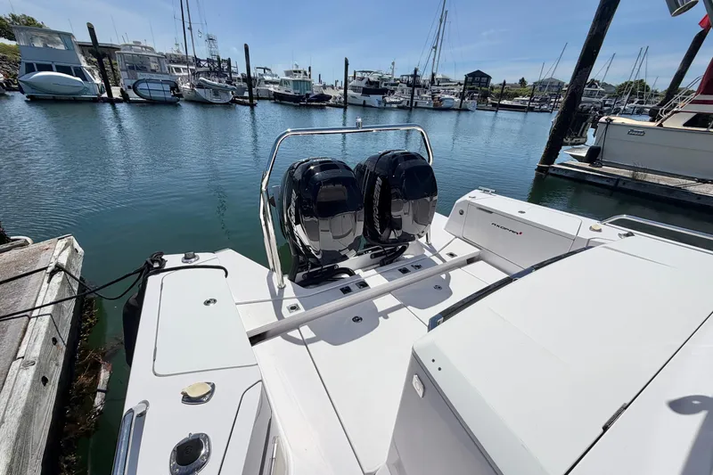 Slide: The Image of 2020 Axopar 37 XC Cross Cabin with dual engines docked at a marina. - 9