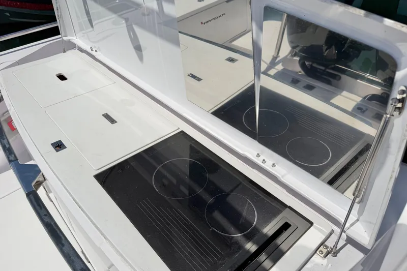 Slide: The Image of 2020 Axopar 37 XC Cross Cabin boat kitchen with sleek stovetop and storage compartments. - 15