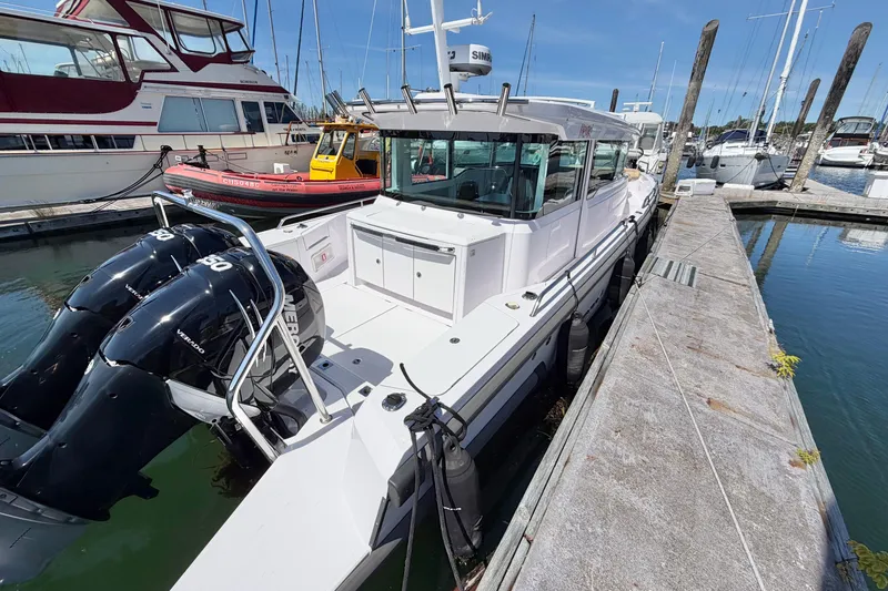 Slide: The Image of 2020 Axopar 37 XC Cross Cabin docked with dual Mercury engines. - 8