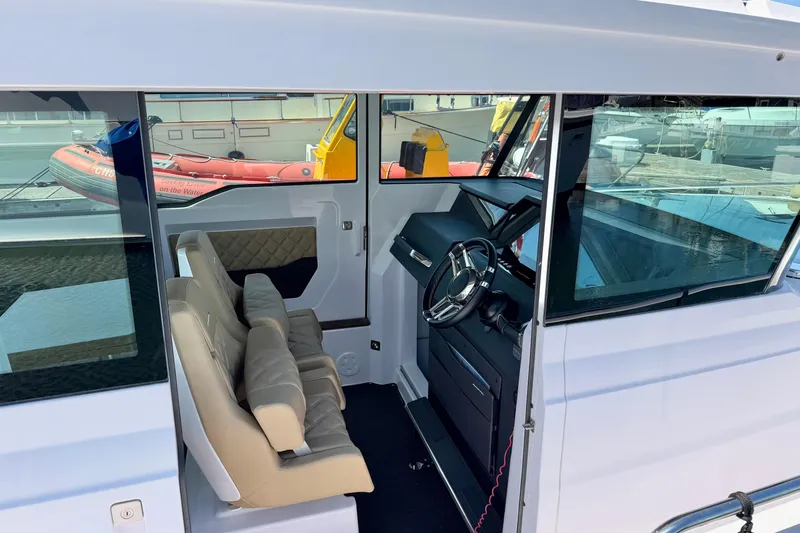 Slide: The Image of Interior view of 2020 Axopar 37 XC Cross Cabin with modern seating and steering wheel. - 22