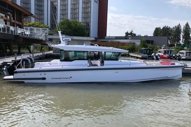 The Image of 2020 Axopar 37 XC Cross Cabin boat docked in a marina, side view. - 0