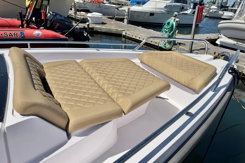 Slide: The Image of Luxurious seating on a 2020 Axopar 37 XC Cross Cabin at a marina. - 20