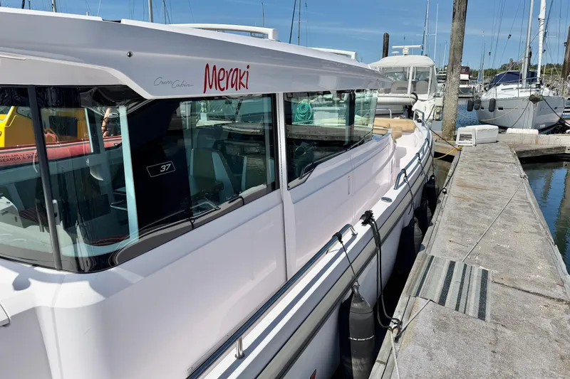 Slide: The Image of 2020 Axopar 37 XC Cross Cabin docked at marina, side view. - 21