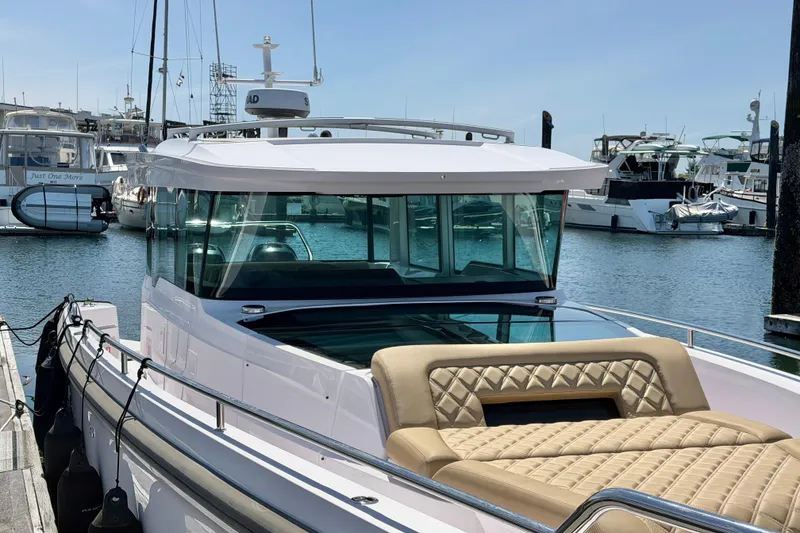 Slide: The Image of 2020 Axopar 37 XC Cross Cabin boat docked in a marina, featuring a sleek design. - 17