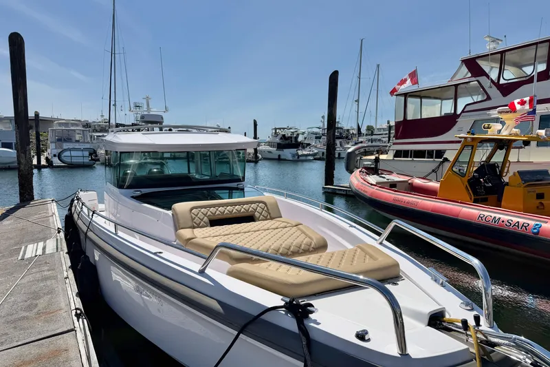Slide: The Image of 2020 Axopar 37 XC Cross Cabin docked at a marina, featuring sleek design and comfortable seating. - 16