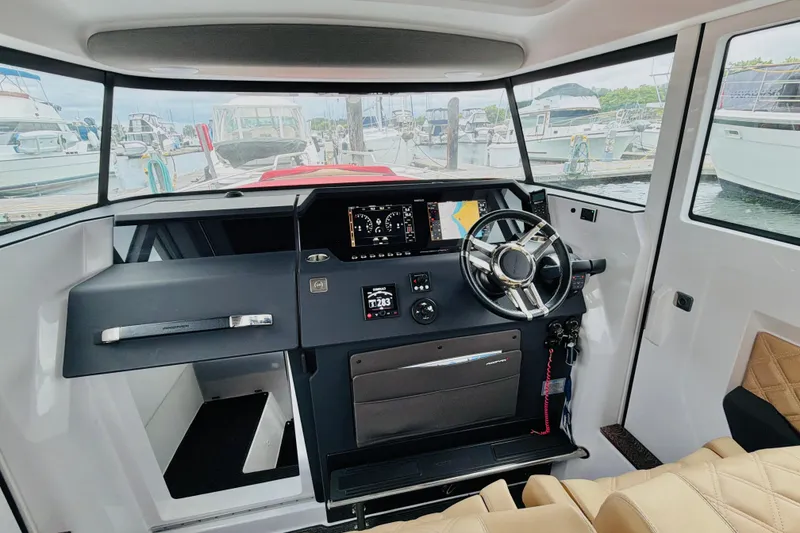Slide: The Image of Interior of 2020 Axopar 37 XC Cross Cabin with modern dashboard and steering wheel. - 31