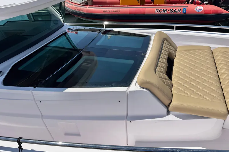 Slide: The Image of 2020 Axopar 37 XC Cross Cabin with beige quilted seating and sleek design. - 18