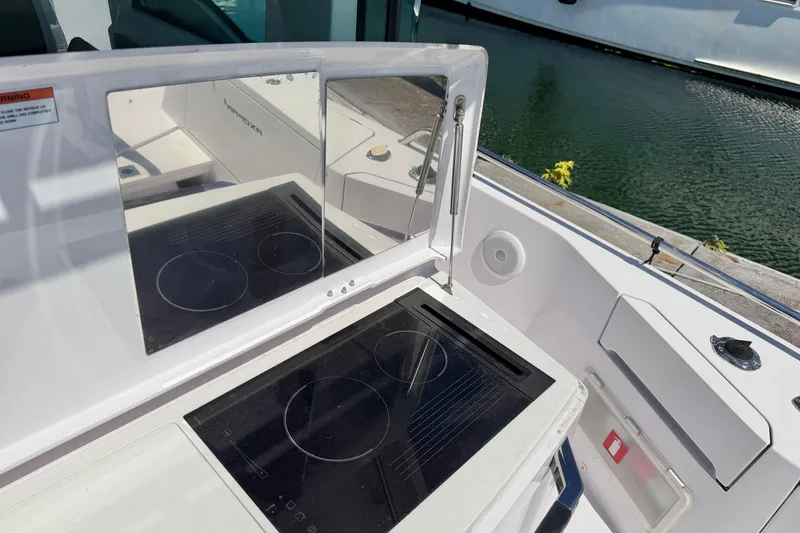 Slide: The Image of Outdoor kitchen on 2020 Axopar 37 XC Cross Cabin boat with stove and mirror. - 14