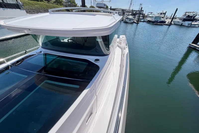 Slide: The Image of 2020 Axopar 37 XC Cross Cabin docked in a marina, showcasing sleek design and modern features. - 37