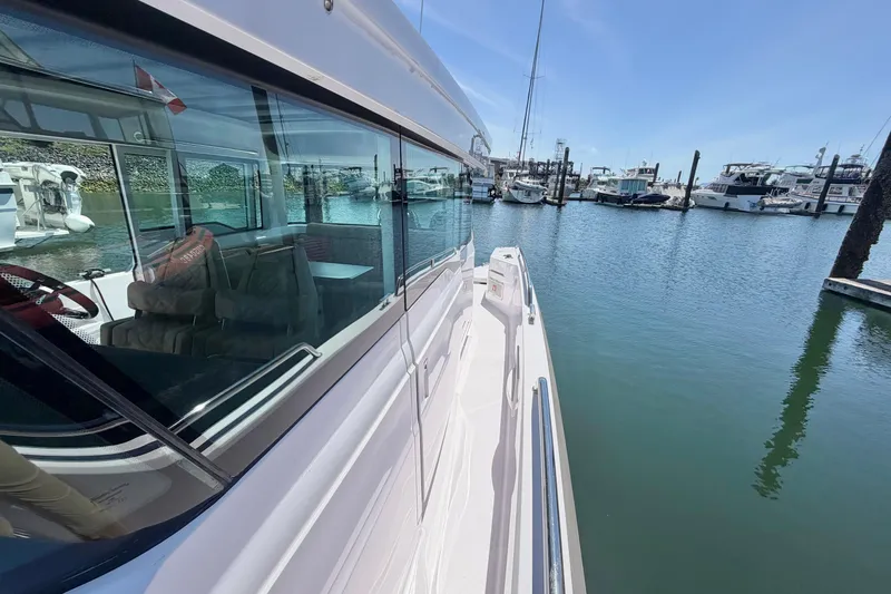 Slide: The Image of 2020 Axopar 37 XC Cross Cabin docked at marina, showcasing sleek design and spacious interior. - 38