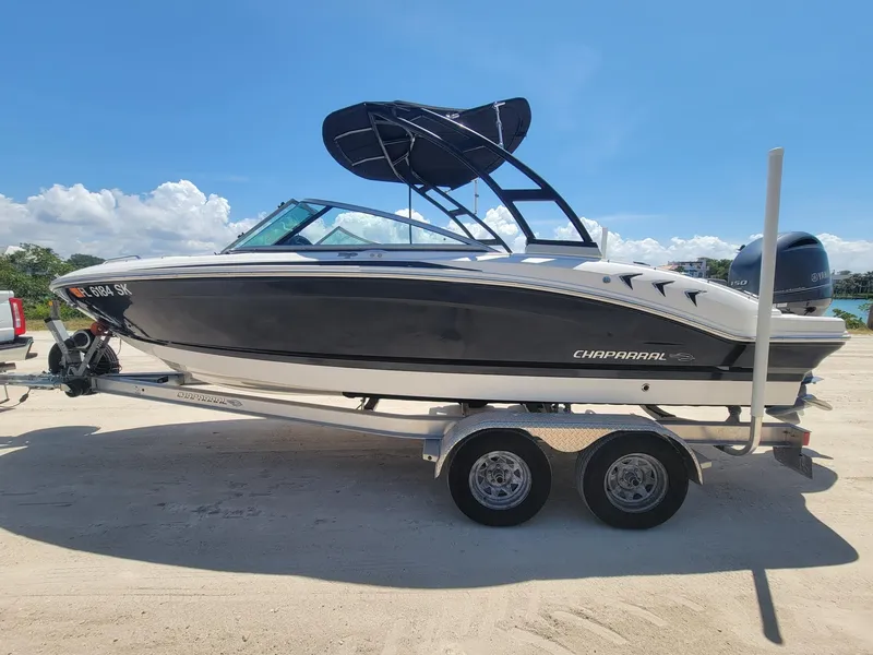The Image of 2016 Chaparral 21 H2O Sport boat on trailer, sunny day. - 1