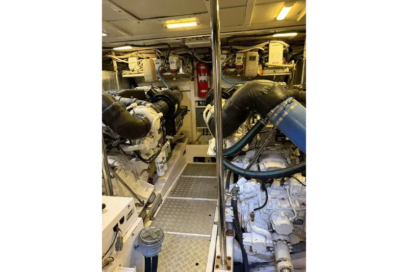 Slide: The Image of Engine room of 2005 Viking Princess V70 Express yacht, featuring dual engines and mechanical systems. - 10