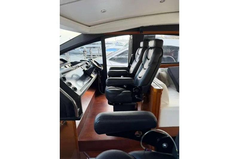 Slide: The Image of Interior of 2005 Viking Princess V70 Express yacht with luxurious black leather seating. - 12