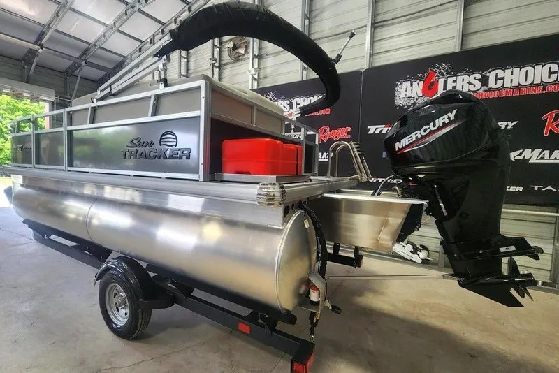 Slide: The Image of 2026 Tracker Bass Tracker Classic XL boat with Mercury engine in showroom. - 3
