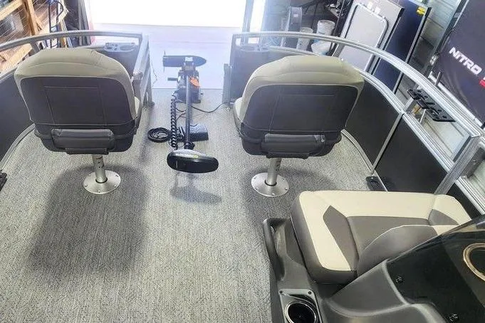 Slide: The Image of 2026 Tracker Bass Tracker Classic XL boat interior with seating and steering console. - 4