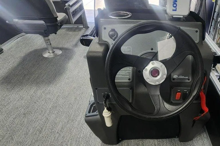 Slide: The Image of 2026 Tracker Bass Tracker Classic XL boat steering console with modern controls and seating. - 6