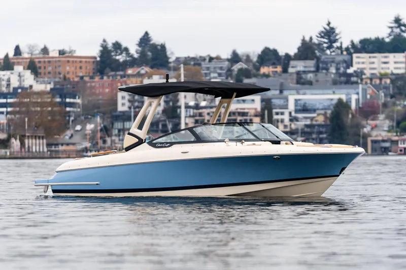 The Image of 2025 Chris-Craft Sportster 25 boat on water with cityscape background. - 0